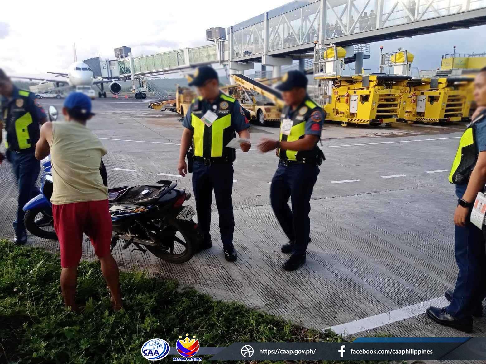 Police officers intercept the trespasser at Bicol Airport.